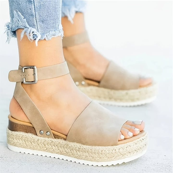 Stylish women's espadrille wedge sandals, featuring an elegant open toe and buckle ankle strap.