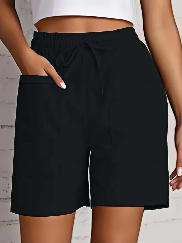 Women's mid-thigh bermuda shorts with functional pockets and an elastic drawstring waist for comfort.