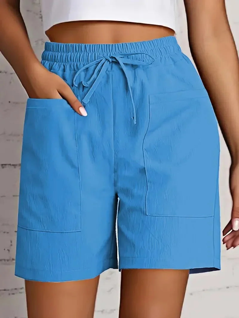 Relaxed fit women's mid-thigh bermuda shorts with pockets & a comfortable drawstring waist for summer.