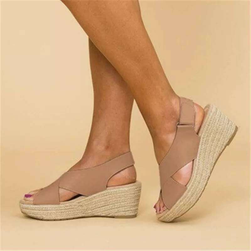 Polished women's crisscross espadrille wedge sandals with a chic slingback design.