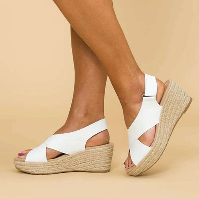 Polished women's slingback espadrille wedge sandals with elegant crisscross straps.