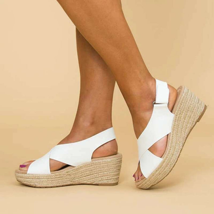 Polished women's slingback espadrille wedge sandals with elegant crisscross straps.