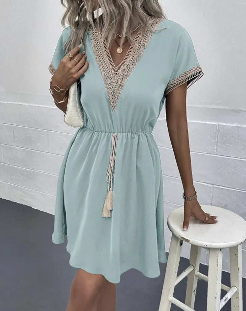 Stylish bohemian flowy dress for women, featuring intricate crochet trim. Ideal vacation wear.