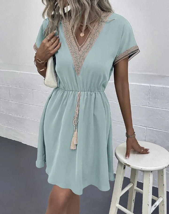 Stylish bohemian flowy dress for women, featuring intricate crochet trim. Ideal vacation wear.