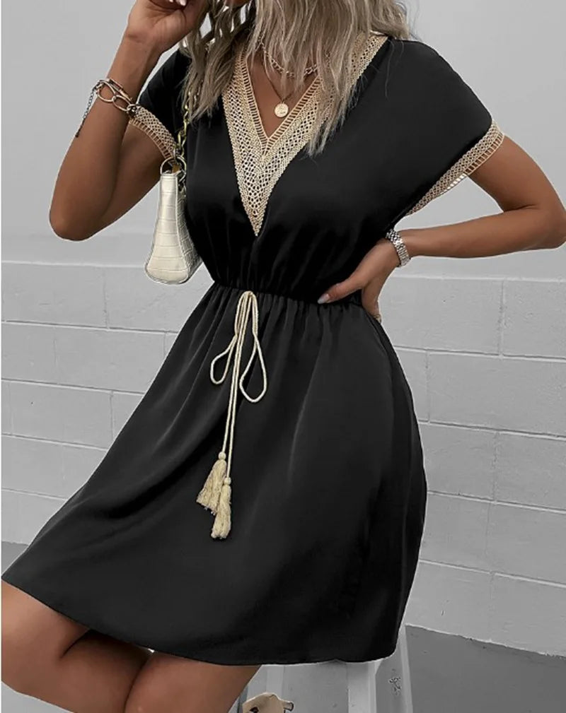 Casual women's summer dress with delicate crochet trim and elegant flutter sleeves.