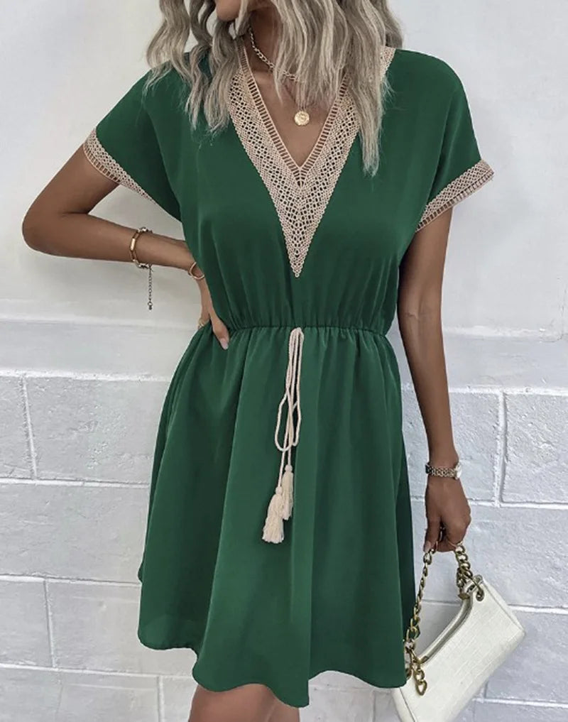 Flowy V-neck boho summer dress for women, detailed with chic crochet trim. Comfortable casual wear.