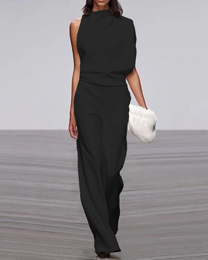 Elegant women's mock neck jumpsuit featuring wide legs & a stylish draped shoulder. Modern style.