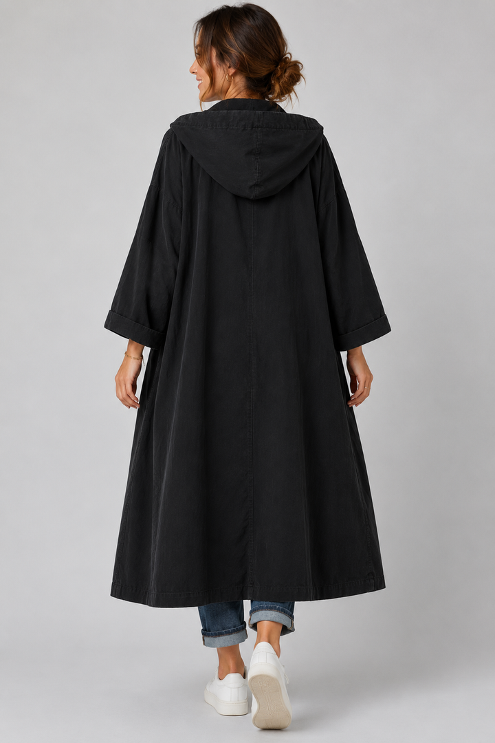 Back view of a women's versatile long trench coat, highlighting the elegant drape and waterproof design.