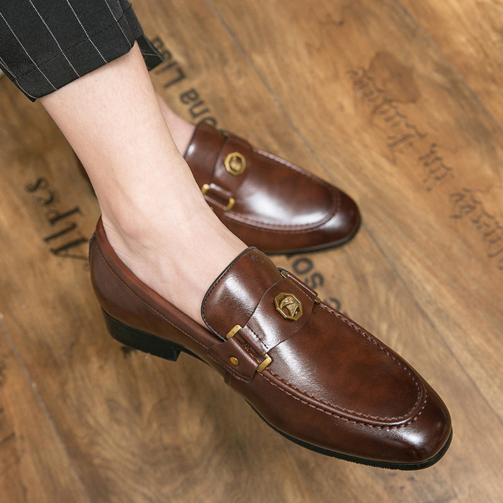 Classic men's black leather slip-on loafers with elegant metal buckle detail, perfect for business casual style.