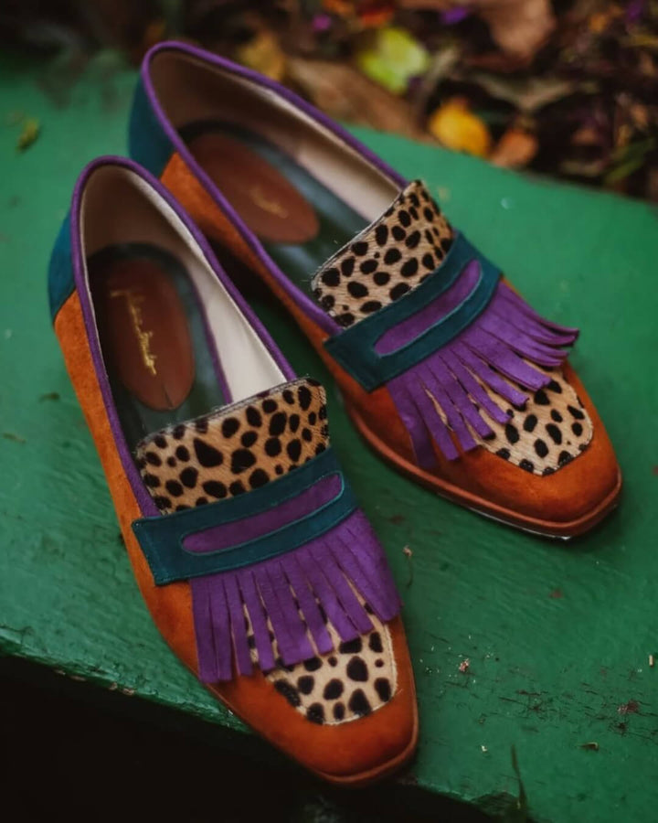 Trendy women's animal print fringe loafers. Comfortable fashion footwear for a chic, statement look.