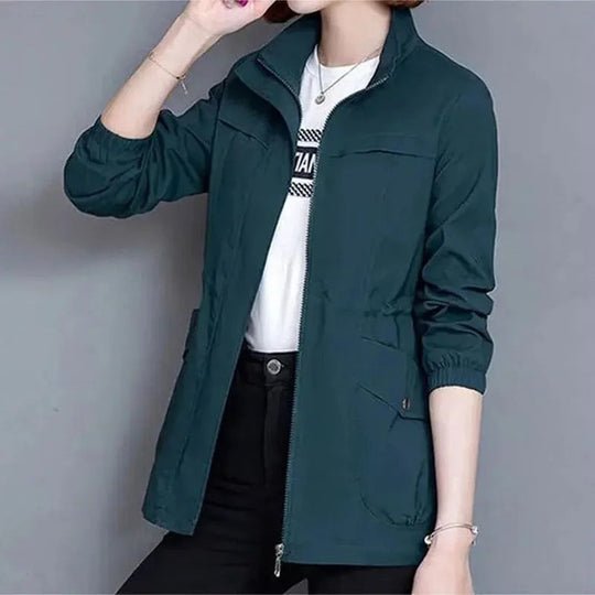 Women's waterproof jacket, flattering cinched waist. Ideal stylish outerwear for everyday and travel.