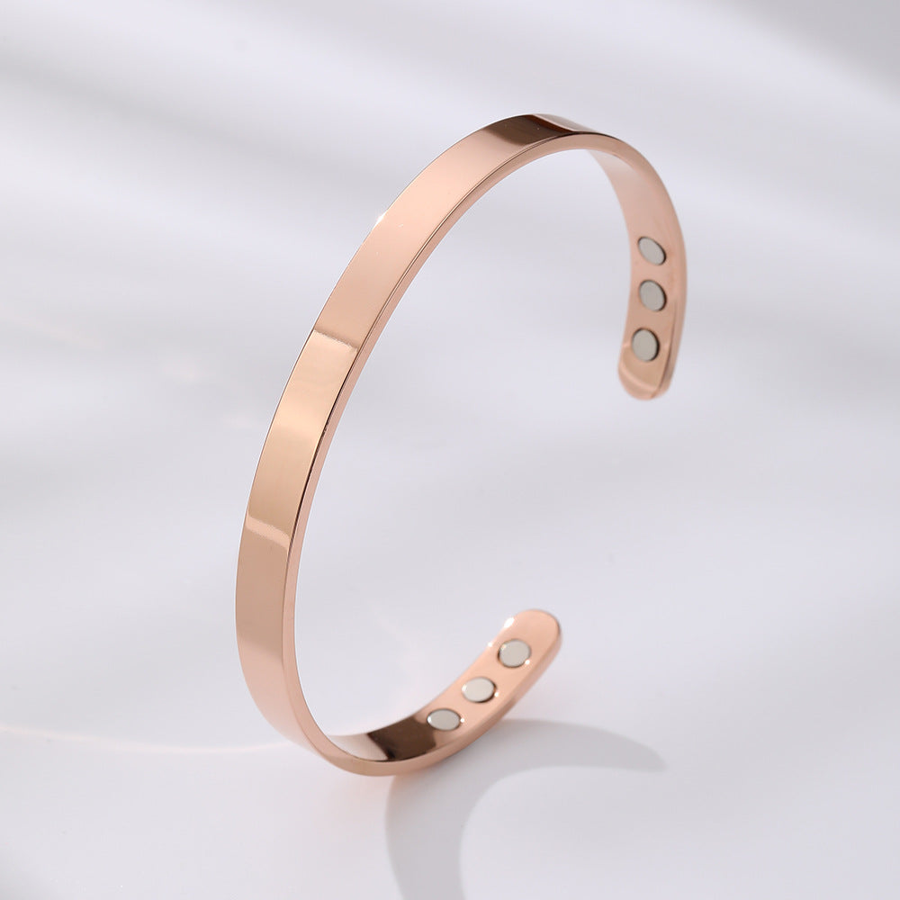 Close-up of a wide glossy stainless steel magnetic cuff bracelet. Modern unisex elegant jewelry.