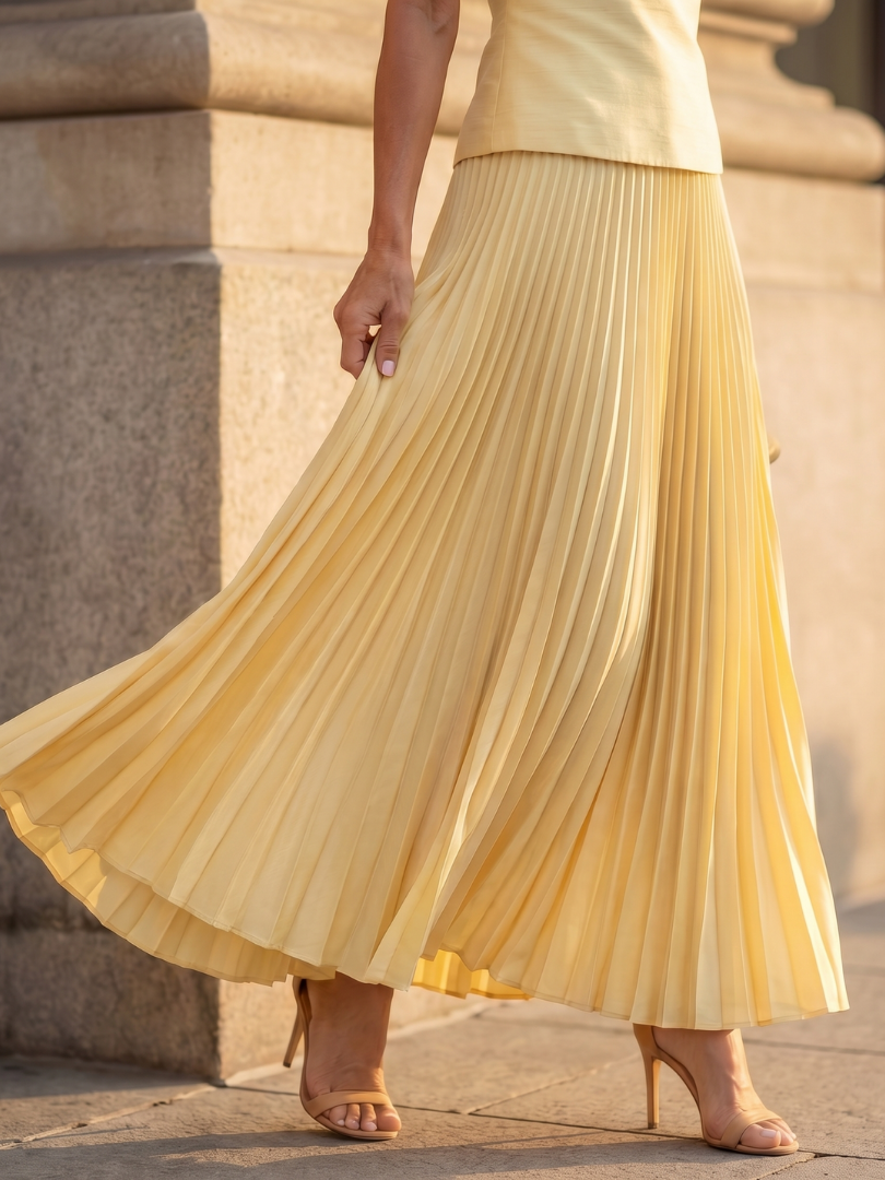 Stylish women's ensemble: sleeveless structured top and elegant pleated maxi skirt two-piece set.