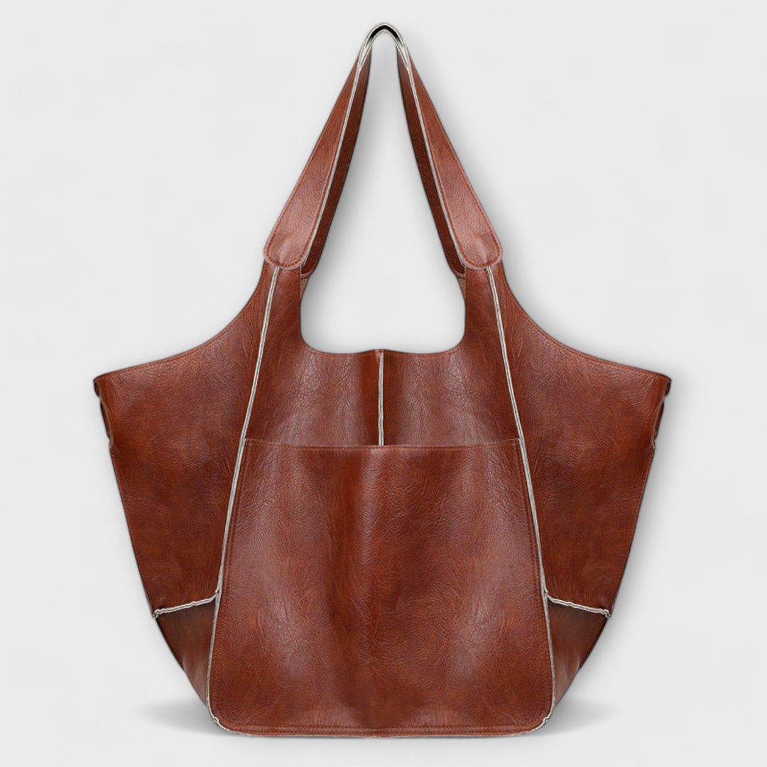 Elegant oversized brown leather travel bag, perfect for short trips or a stylish gym bag.