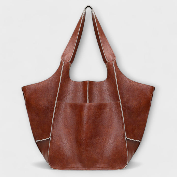Elegant oversized brown leather travel bag, perfect for short trips or a stylish gym bag.