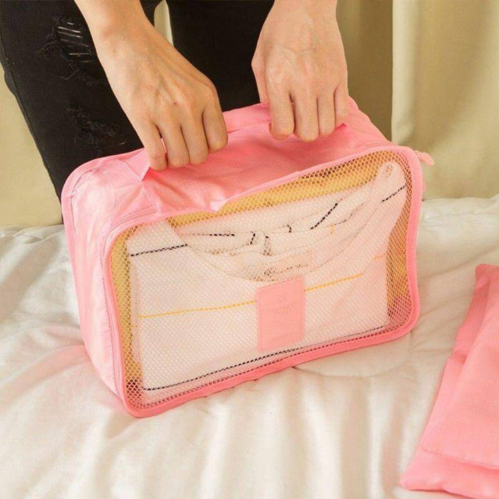 Assorted sizes of packing cubes in a luggage organizer set. Maximize suitcase space easily.