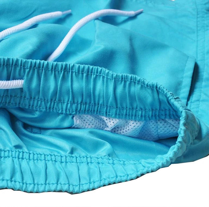 Men's quick-drying swim shorts. Relaxed fit with drawstring waist. Ideal for summer beach & pool activities.