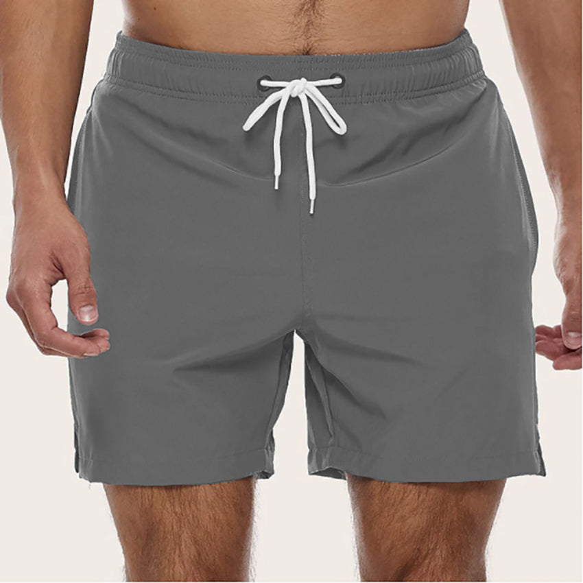 Men's quick-dry swim shorts with a relaxed fit & drawstring. Essential beachwear for summer.