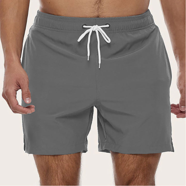 Men's quick-dry swim shorts with a relaxed fit & drawstring. Essential beachwear for summer.