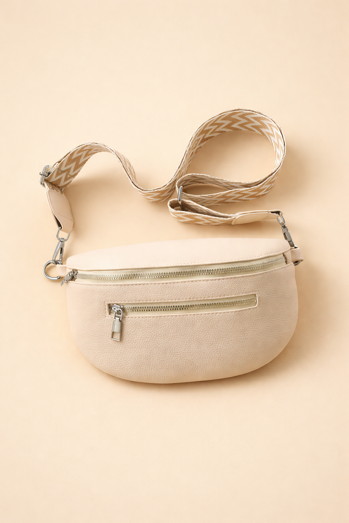 Stylish grey women's belt bag worn as a crossbody, a versatile and modern accessory for fashion-forward women.