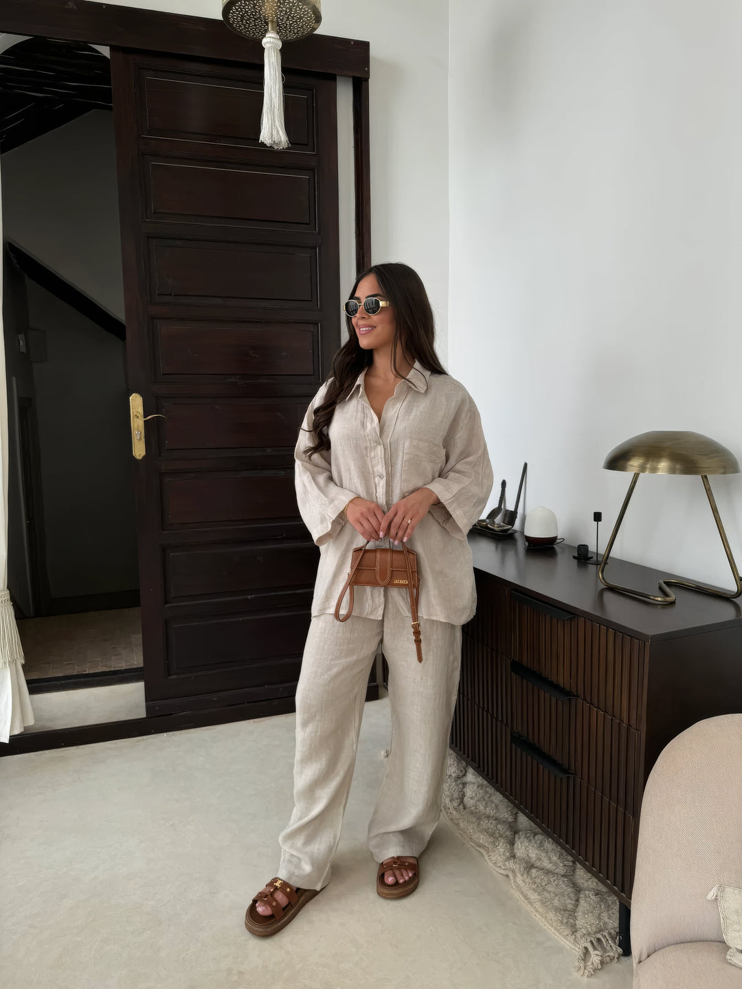 Beige women's stylish two-piece set with long sleeve top & wide-leg pants, perfect for summer comfort.