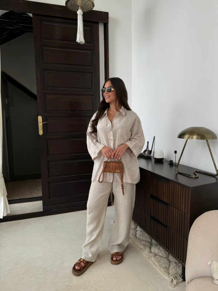 Beige women's stylish two-piece set with long sleeve top & wide-leg pants, perfect for summer comfort.