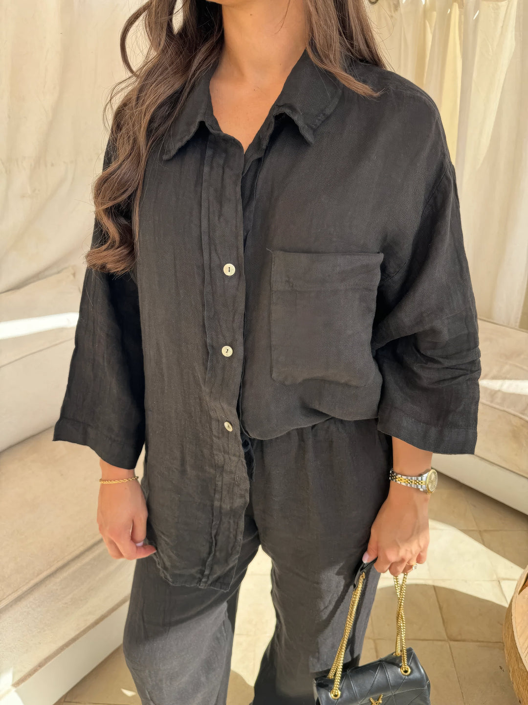 Women's black two-piece set: comfortable wide-leg pants & long sleeve top, versatile for casual or elegant summer wear.