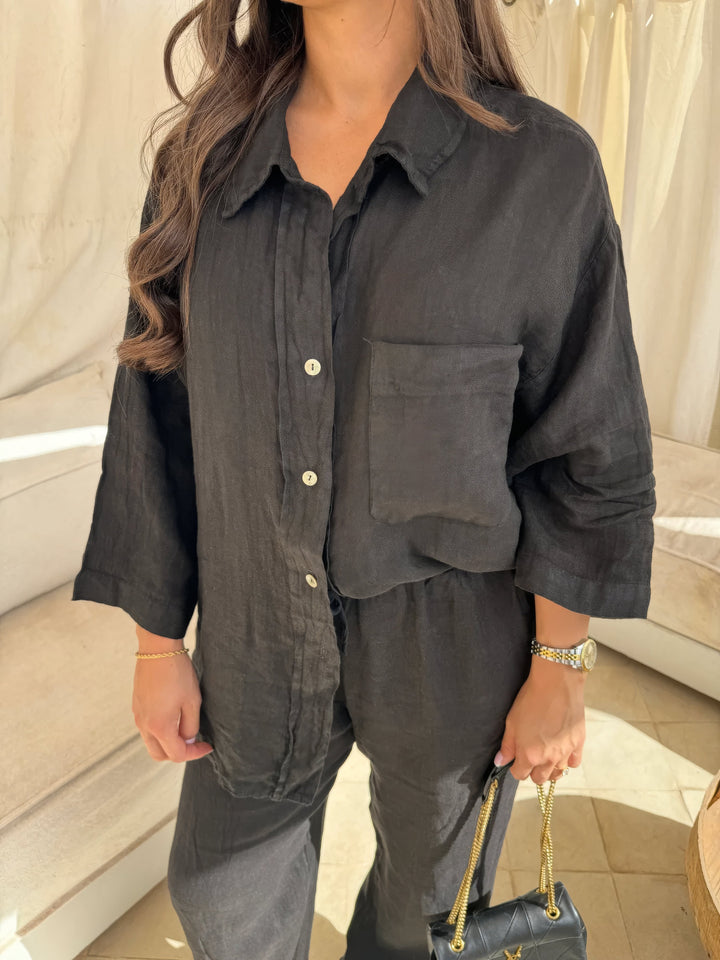 Women's black two-piece set: comfortable wide-leg pants & long sleeve top, versatile for casual or elegant summer wear.
