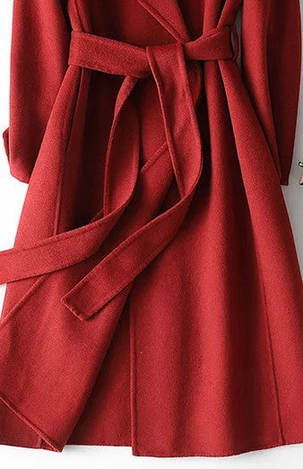 Fashionable women's burgundy A-line wrap coat with a sleek belt, offering elegant seasonal outerwear for winter.