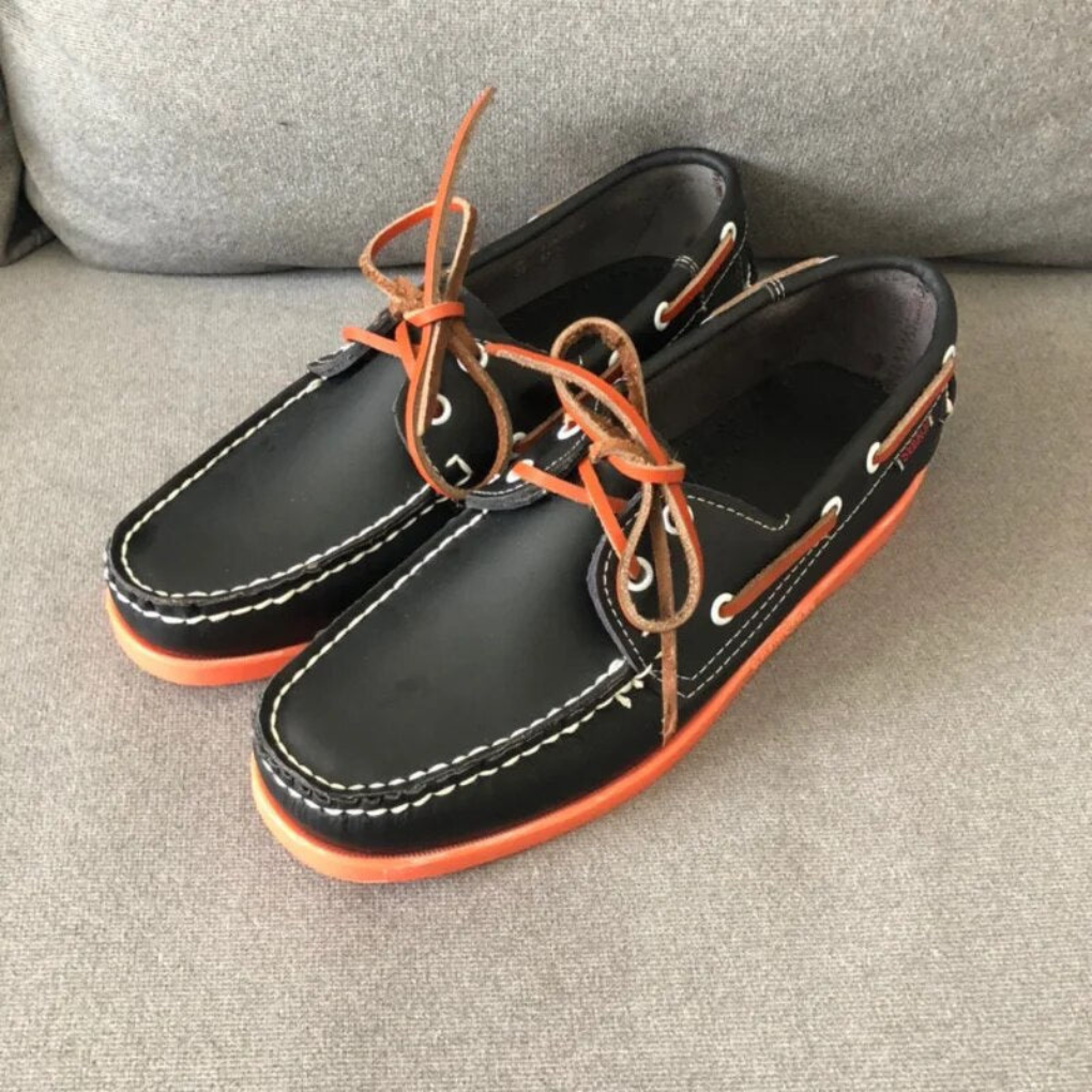 Graceful men's two-tone lace-up boat shoes, offering comfort and a timeless look for casual footwear.