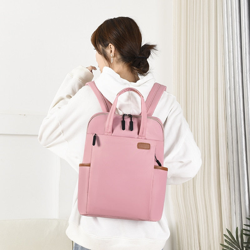 Water-resistant Oxford anti-theft backpack, sleek design for work, school, or travel.
