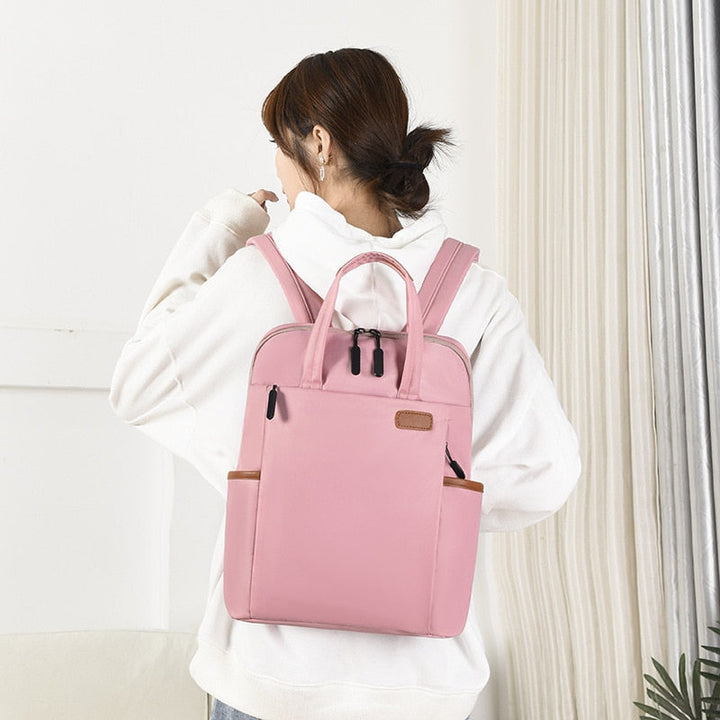 Water-resistant Oxford anti-theft backpack, sleek design for work, school, or travel.