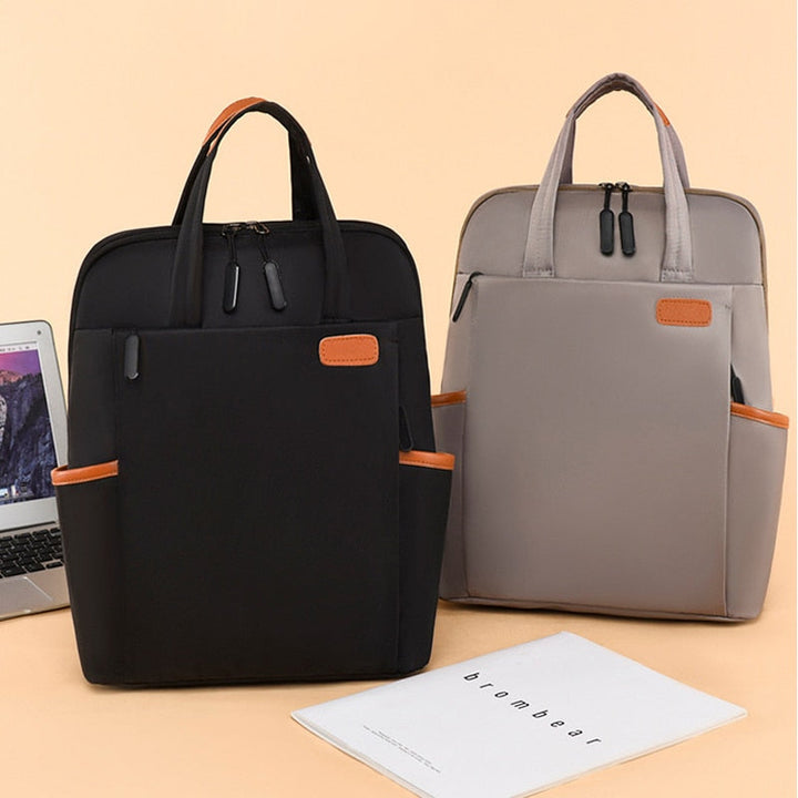 Organized anti-theft travel bag in cream, secure pockets & water-resistant material.