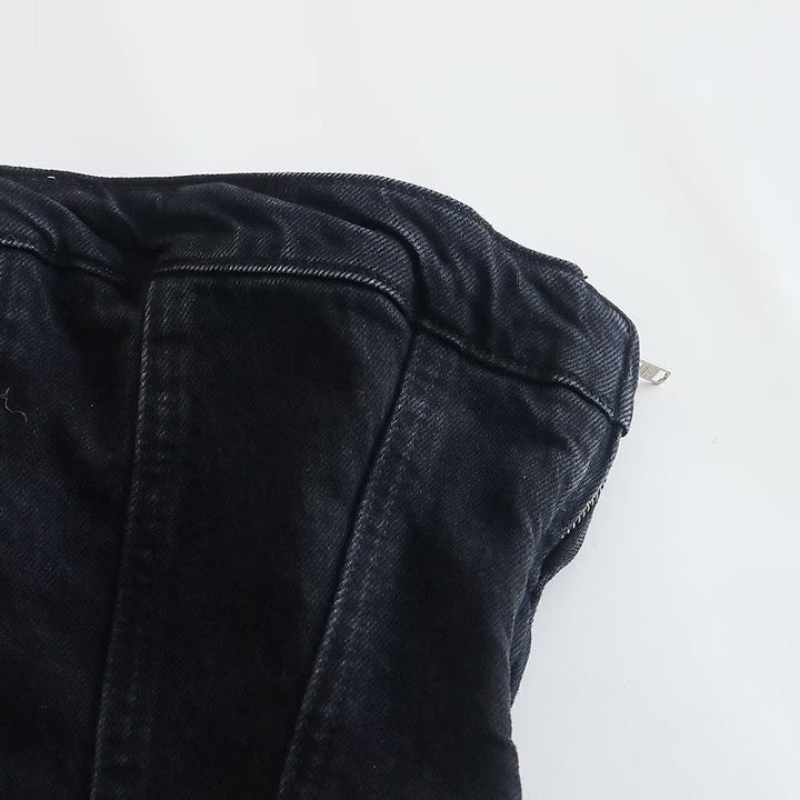 Close-up of the quality stitching on a chic women's strapless denim mini dress, highlighting craftsmanship.