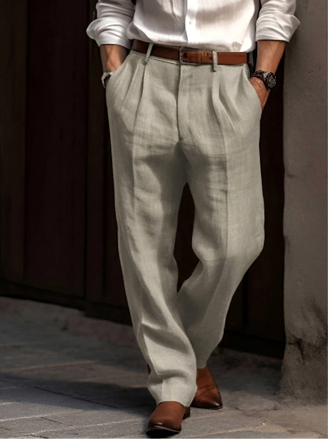 Men's classic pleated dress trousers in a smart neutral shade, a key piece for modern men's fashion.