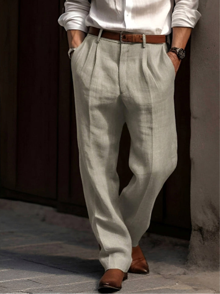 Men's classic pleated dress trousers in a smart neutral shade, a key piece for modern men's fashion.