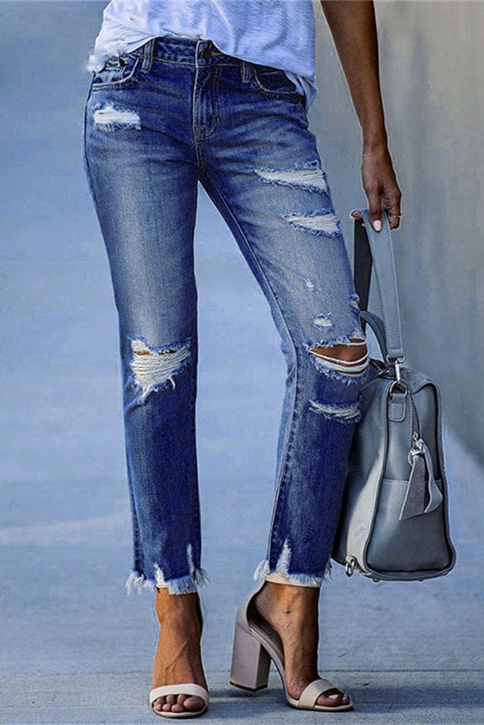 Back view of women's straight leg distressed jeans, highlighting mid-rise fit and stylish raw hem detail.