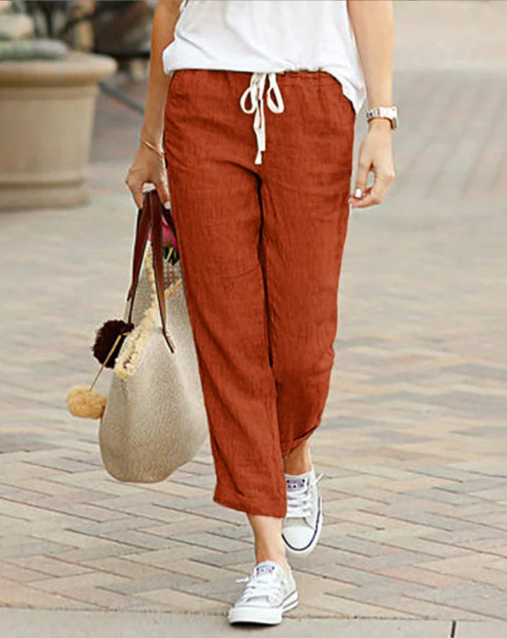 Chic women's cropped linen pants, featuring a polished finish and adjustable drawstring for a relaxed, comfortable fit.