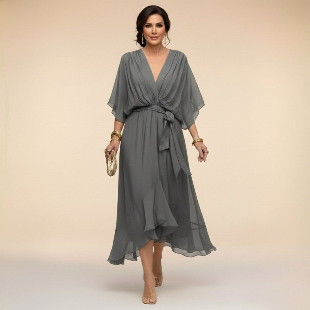 Flowing Women's V-Neck Midi Dress in a vibrant color, showing movement. Features a flattering V-neck and adjustable waist.
