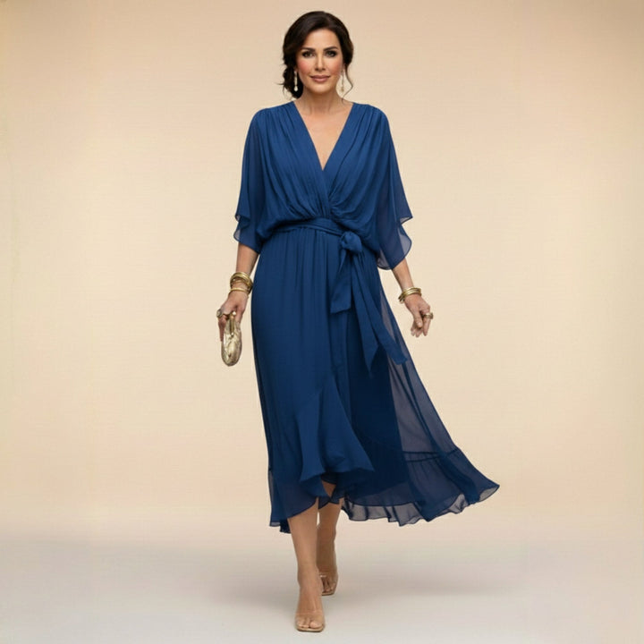 Stylish blue Women's V-Neck Flowing Midi Dress, ideal for summer. Features a flattering V-neck and adjustable waist.