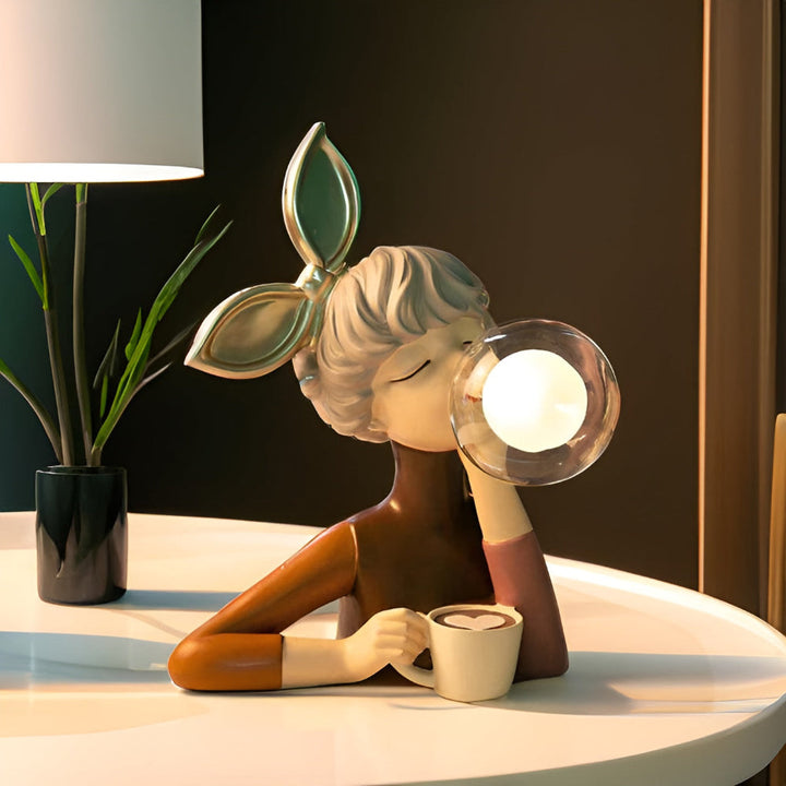 Artistic enchanting girl figurine LED table lamp, providing whimsical charm and unique home lighting.