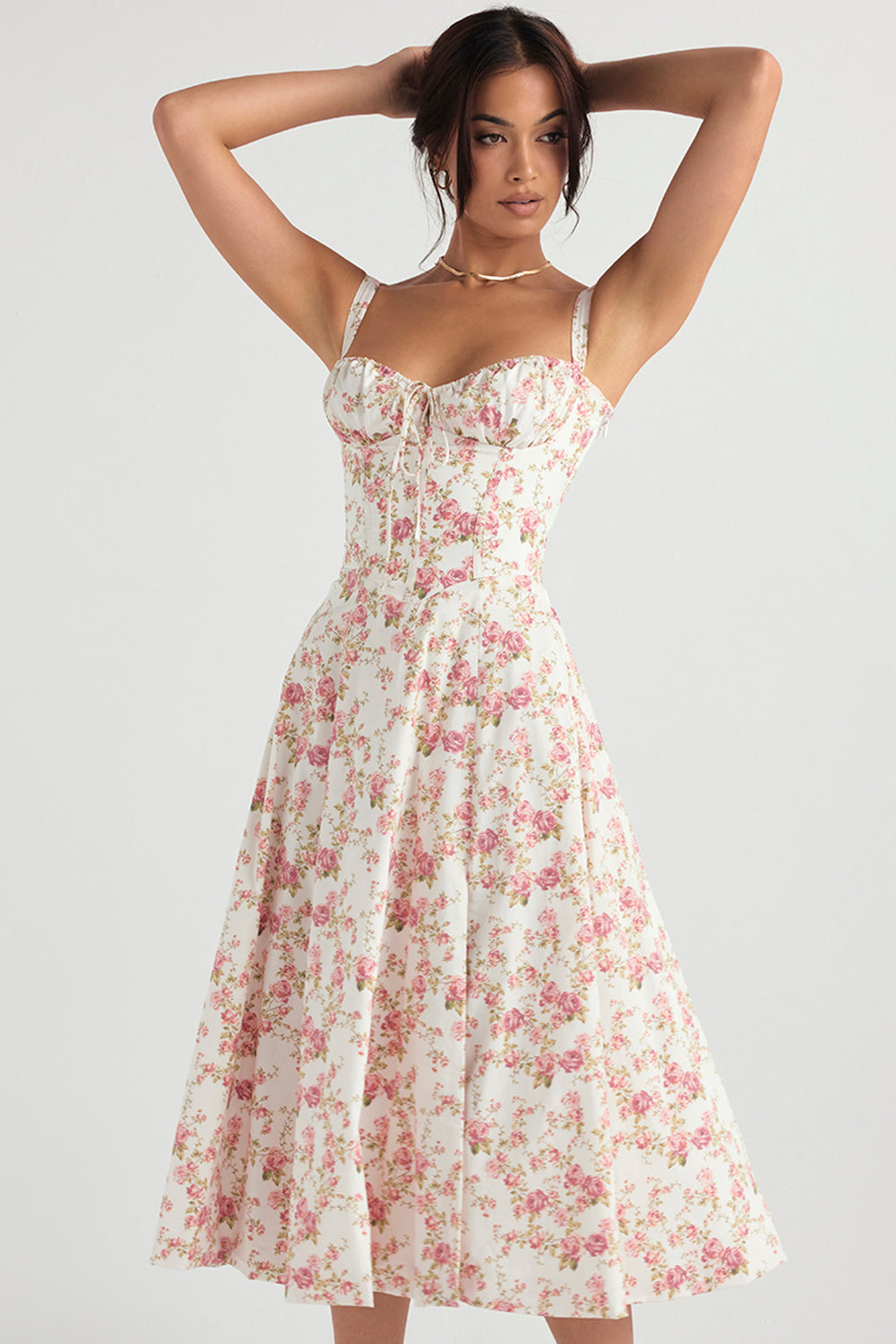 Feminine bustier floral summer dress with a flattering waist-shaping design, styled for daytime.