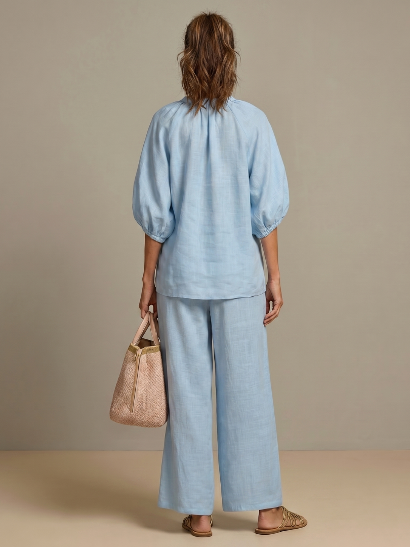 Spring/summer women's two-piece outfit; blouson zip-front top & wide-leg pants.