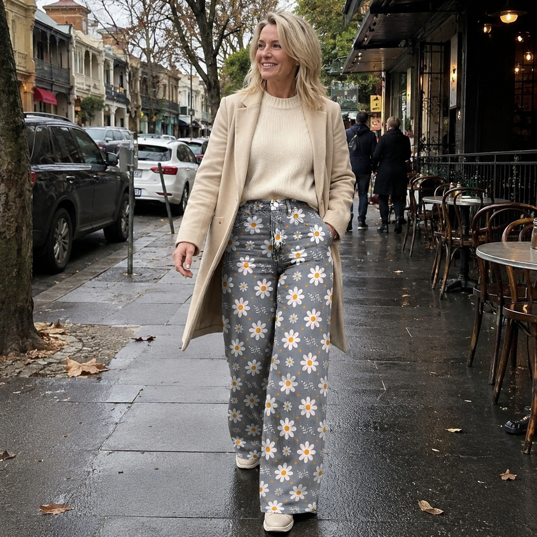 Vibrant floral print on women's high waist wide leg jeans. Fashionable statement piece for casual or dressed-up looks.