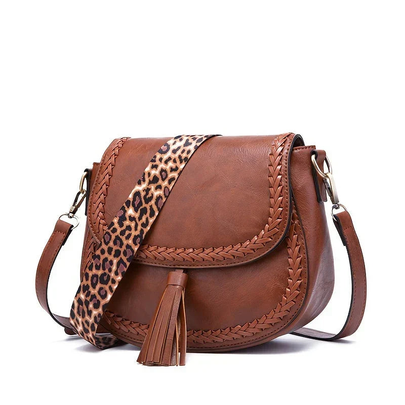 Stylish women's faux leather handbag with a chic tassel, a perfect everyday fashion accessory.