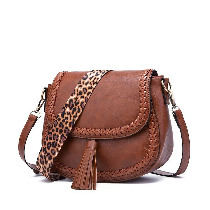 Stylish women's faux leather handbag with a chic tassel, a perfect everyday fashion accessory.