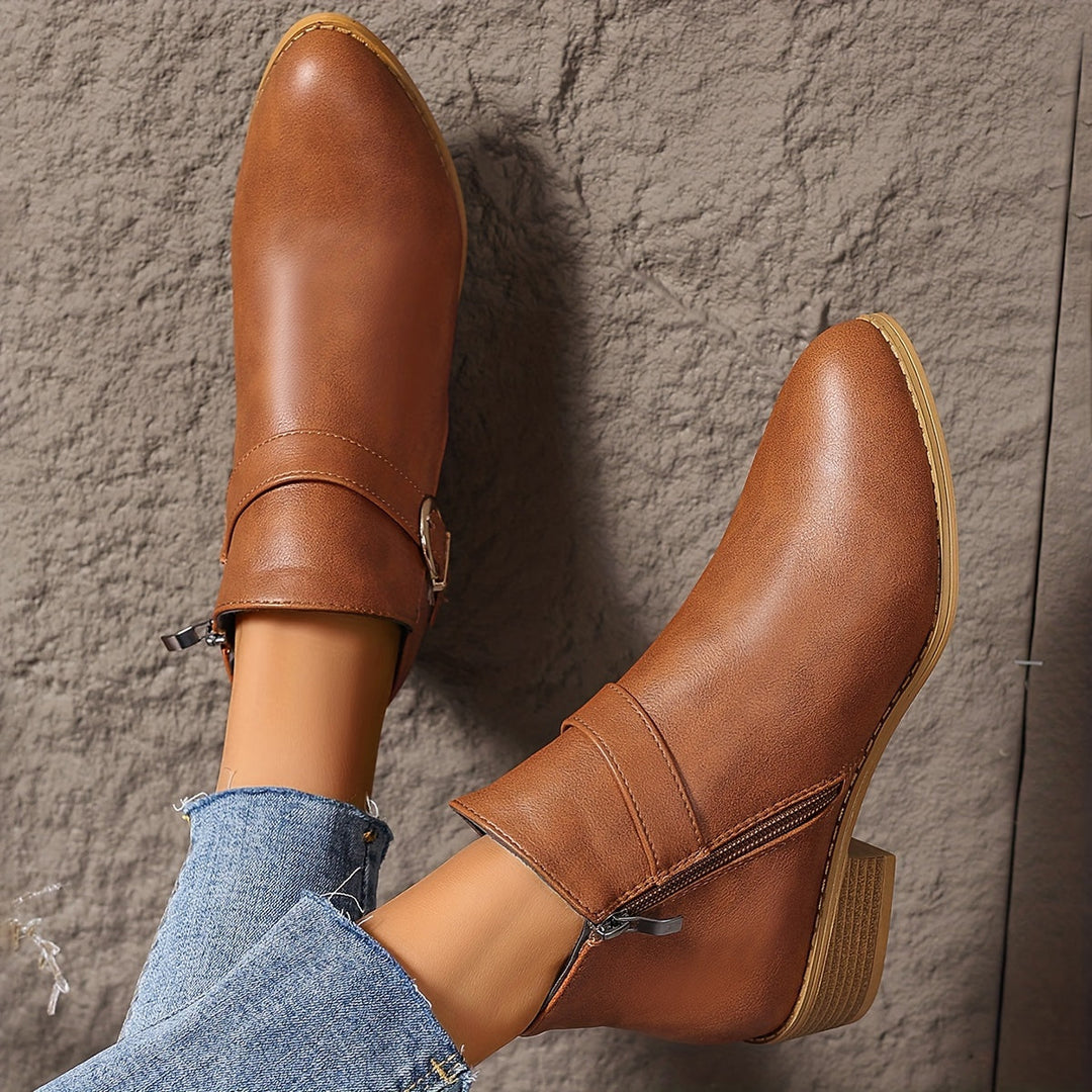 Fashionable green Chelsea ankle boots for women, featuring a prominent modern buckle and comfortable low heel.