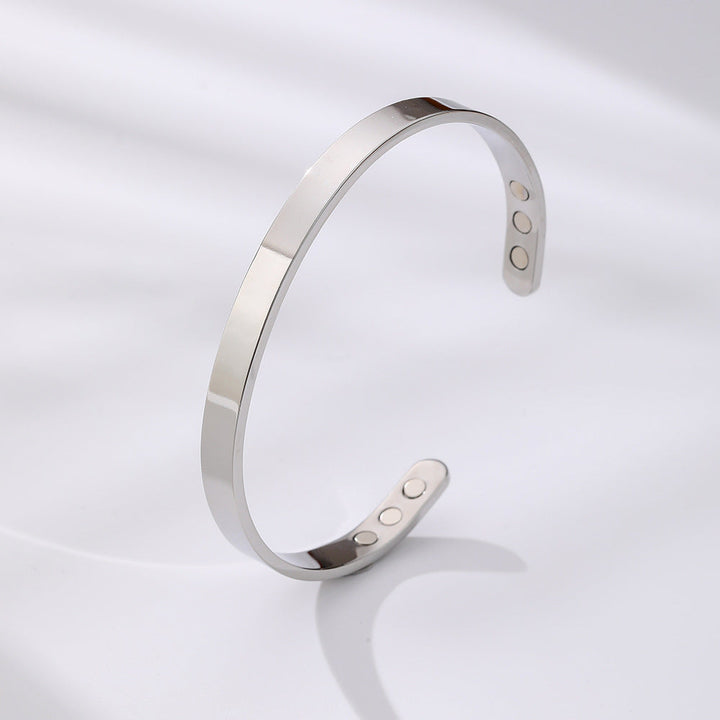 Contemporary wide stainless steel magnetic cuff bracelet with a high gloss finish. Unisex fashion.