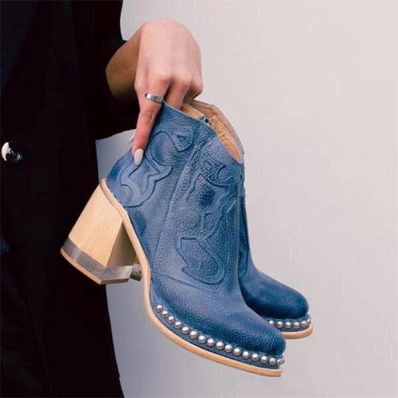Chic women's western ankle boots, featuring stylish cut-outs, a block heel, and cowboy boot aesthetic.