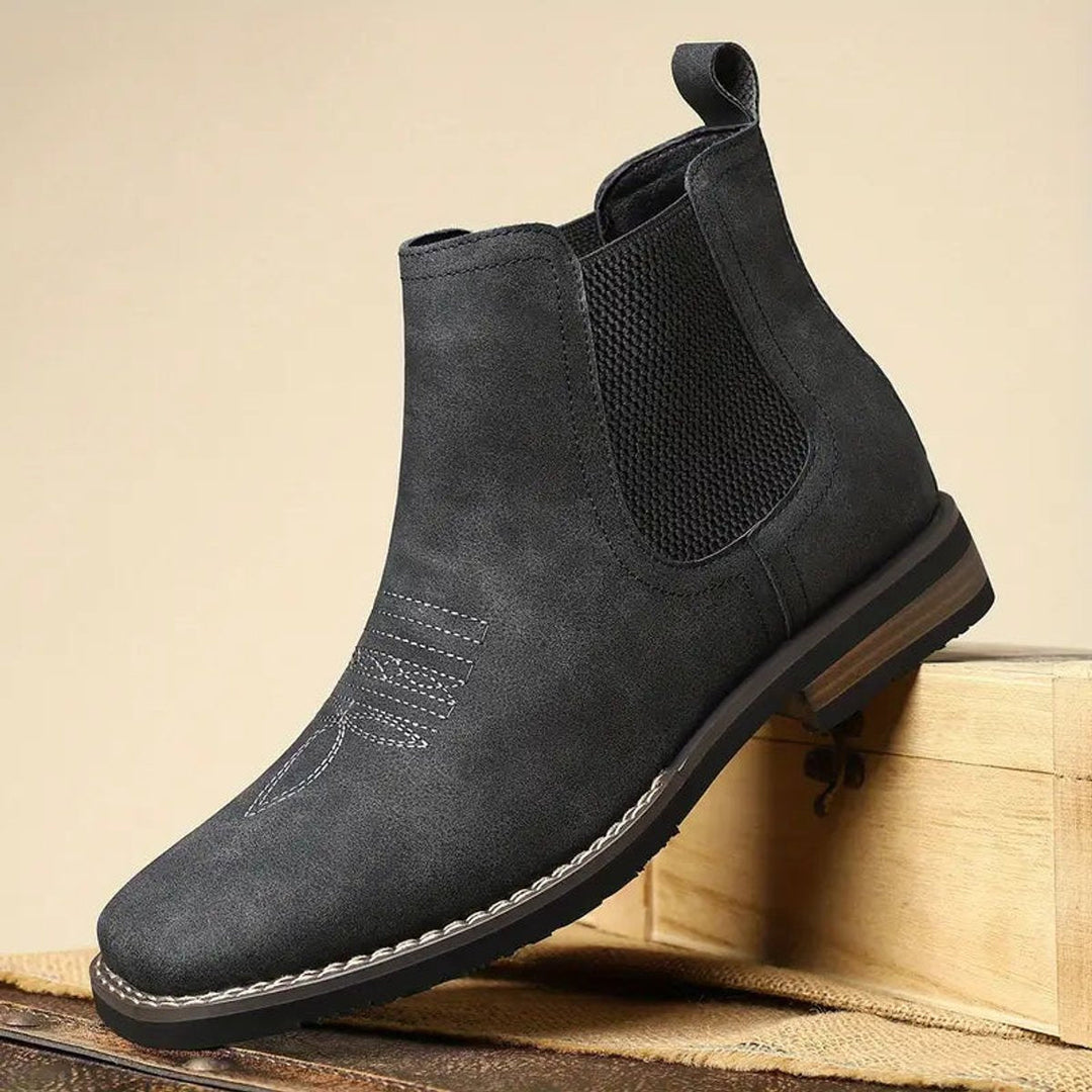 Brown suede men's slip-on Chelsea ankle boots, offering comfort and smart-casual style. Durable footwear.